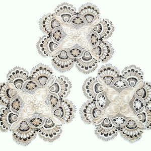 May include: Three white and black lace doilies with a delicate floral design.