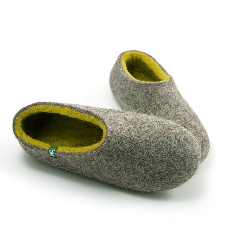 May include: A pair of gray wool slippers with a lime green lining. The slippers are soft and comfortable, perfect for keeping your feet warm in the winter.