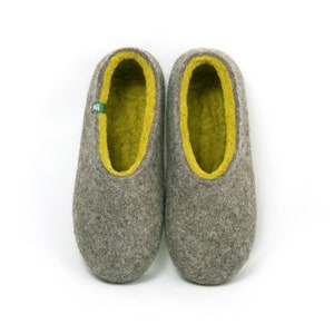 May include: A pair of gray wool slippers with a yellow felt lining. The slippers have a rounded toe and a flat sole.