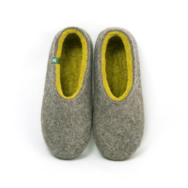 May include: A pair of gray wool slippers with a yellow felt lining. The slippers have a rounded toe and a flat sole.