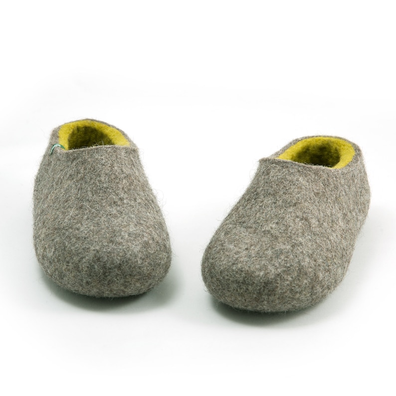 May include: A pair of gray wool slippers with a yellow lining. The slippers are soft and comfortable, perfect for keeping your feet warm in the winter.