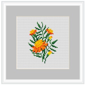 Può includere: Ricamo a punto croce di un bouquet di calendule arancioni e gialle con steli e foglie verdi su uno sfondo bianco.