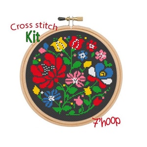 May include: Cross stitch kit featuring a colorful floral design on a black background. The kit includes a 7-inch hoop.