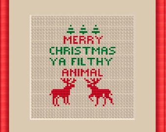 May include: Cross-stitch pattern featuring a Christmas-themed design with the text "Merry Christmas Ya Filthy Animal" and two red reindeer.