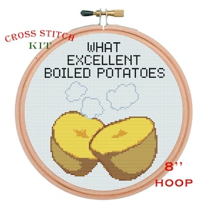 May include: Cross stitch kit featuring a design of two halves of a boiled potato with steam rising. The text reads "WHAT EXCELLENT BOILED POTATOES." The hoop is 8 inches in diameter.
