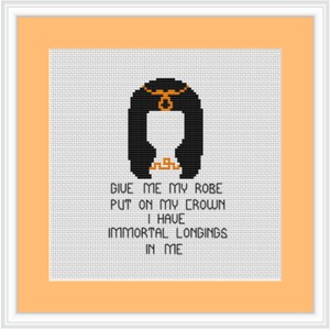 May include: Cross-stitch pattern featuring a black and orange illustration of a woman with a crown and the text "Give me my robe put on my crown I have immortal longings in me."