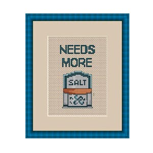 May include: Cross-stitch pattern with a salt shaker and the text "Needs More Salt" in a blue frame.