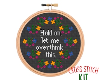 May include: Cross stitch kit featuring a black embroidery hoop with a colorful floral design and the text "Hold on, let me overthink this." The kit includes a 7-inch hoop.