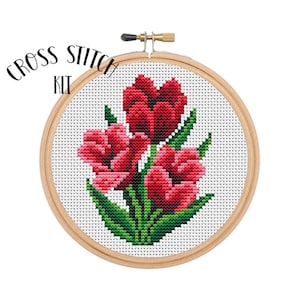 May include: Cross stitch kit featuring a design of three red tulips with green leaves. The kit is displayed in a wooden embroidery hoop.