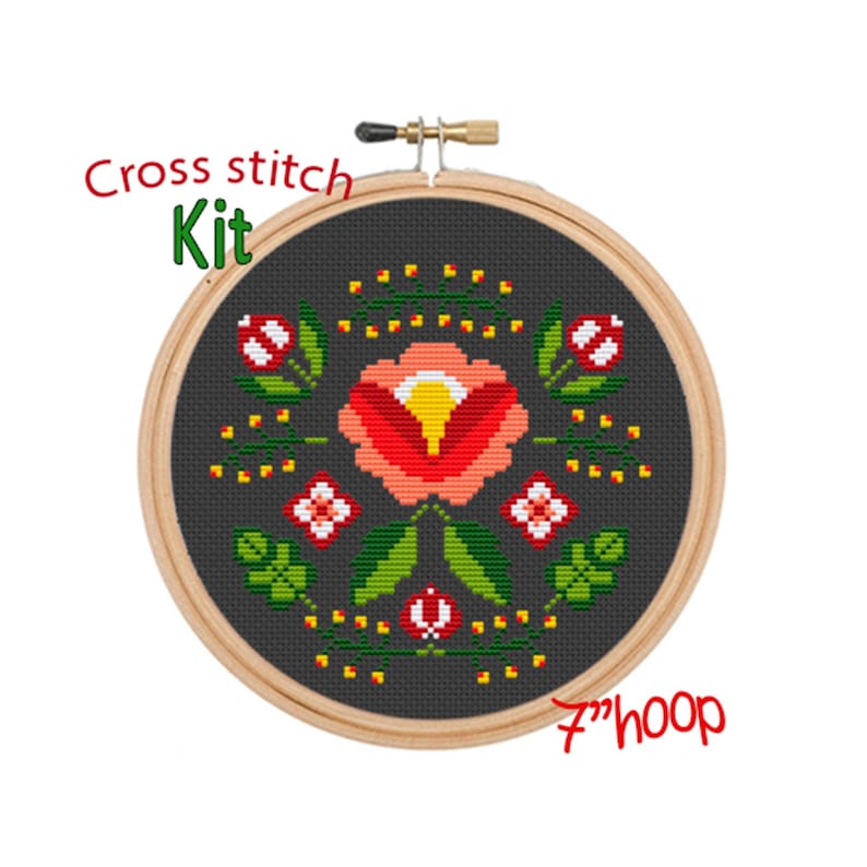 May include: Cross stitch kit featuring a floral design with a red, orange, and yellow flower surrounded by green leaves and yellow dots on a dark gray background. The kit includes a 7-inch hoop.