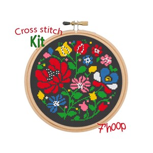 May include: Cross stitch kit featuring a colorful floral design with red, yellow, blue, green, and pink flowers on a black background. The kit includes a 7-inch hoop.