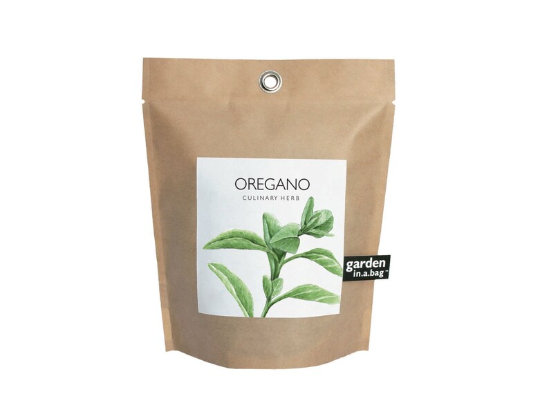 May include: A brown paper bag with a white label that says "OREGANO CULINARY HERB" and features a watercolor illustration of oregano. The bag has a metal grommet and a black label that says "garden in a bag".