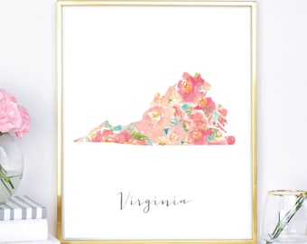 May include: A printable art print featuring a floral design in shades of pink and peach, shaped like the state of Virginia. The print is framed in a gold frame and the word "Virginia" is written in cursive below the floral design.