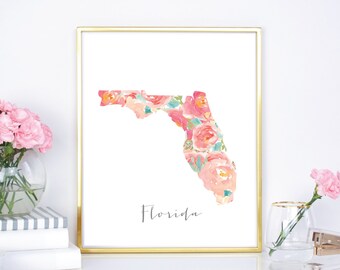 May include: A printable art print featuring a floral design in shades of pink, peach, and green. The design is shaped like the state of Florida and the word "Florida" is printed below the design.