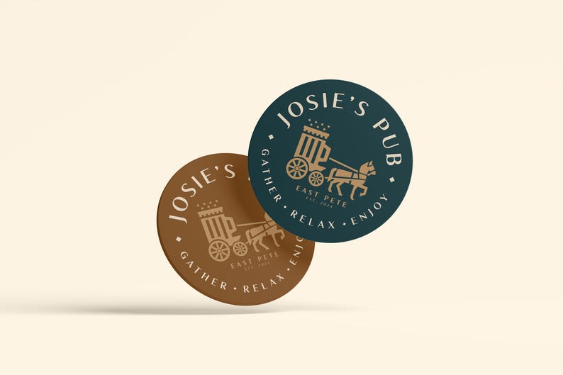 May include: Two round coasters with a brown and a teal background. Both coasters feature a gold illustration of a horse-drawn carriage with the text "Josie's Pub" and "Gather, Relax, Enjoy" on the teal coaster and "East Pete" on both coasters.
