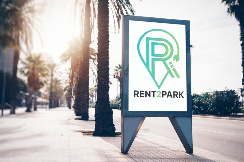 May include: A white billboard with a green and blue logo that says "RENT2PARK" and a stylized letter "R" with a keyhole inside. The billboard is on a street with palm trees.