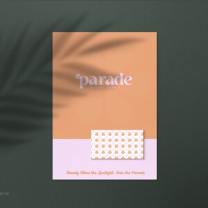 May include: A peach-colored poster with the text "*parade* beauty supply" in white. A small pink and white card with a floral pattern is placed on the poster. The text "Beauty Takes the Spotlight, Join the Parade" is at the bottom of the poster.