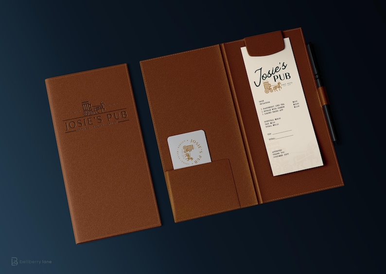 May include: A brown leather folder with a menu inside. The menu is for Josie's Pub and has a logo of a beer mug and a horse-drawn carriage. The folder has a pocket on the front for a business card.