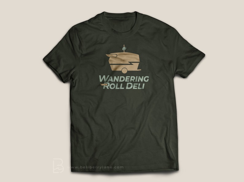 May include: A dark green t-shirt with a graphic of a vintage food truck with the text "Wandering Roll Deli" in a light green and brown font.