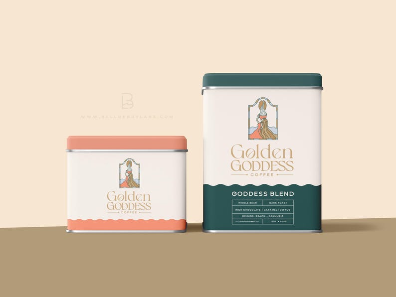 May include: Two metal coffee canisters with a pink and green lid. The canisters are labeled "Golden Goddess Coffee" and feature a graphic of a woman in a dress with long hair. The text "Goddess Blend" is printed on the green canister.