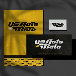 May include: A black and yellow business card with the text "US Auto Moto" in white lettering. The card has a black background with a yellow logo and the website address "www.usautomoto.com".