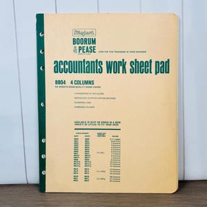 May include: A vintage accountants work sheet pad with a green spine and a cream-colored cover. The cover features the text "accountants work sheet pad" in green, along with other details about the pad's specifications.