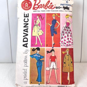 May include: A vintage Advance sewing pattern envelope for Barbie fashion doll clothing, numbered 9938. The front features six illustrations of doll outfits, including dresses, a jumpsuit, and a coat, with the text Barbie and Advance printed.