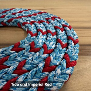 May include: A close-up of a braided rope with a blue and white pattern and a red stripe. The rope is braided in a herringbone pattern. The text "Tide and Imperial Red" is visible at the bottom of the image.