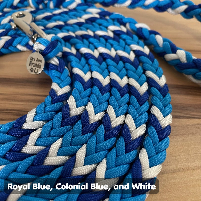 May include: A braided dog leash in royal blue, colonial blue, and white. The leash is made of paracord and has a silver clip.