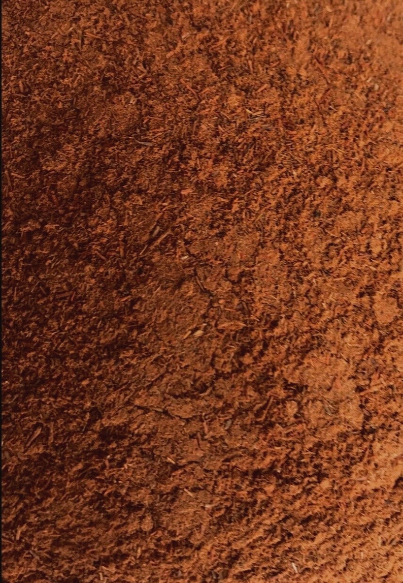 May include: Close-up of a brown suede fabric with a textured surface.