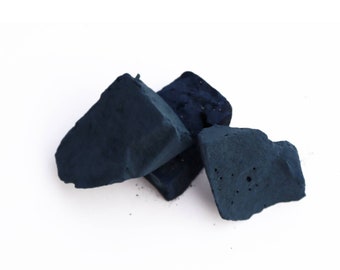 May include: Three dark blue indigo dye blocks, a natural dye used for dyeing fabrics.