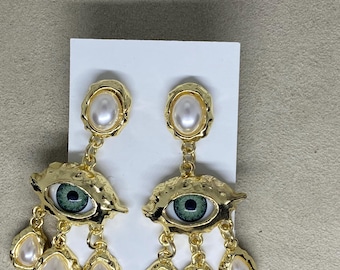 Joan Rivers “eye earrings”