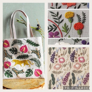 Puede incluir: Una bolsa de lona blanca con un diseño bordado de colores que incluye un leopardo amarillo, flores rosas, hojas verdes y cuentas blancas. La bolsa está sobre una superficie de madera.