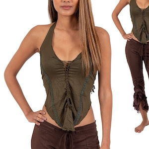 May include: A green halter top with lace trim and a tie-up front. The top is worn with brown pants that have a ruffled hem.