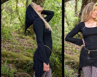 May include: A black long-sleeved top with a hood and a high-low hemline. The top is worn with patterned leggings.
