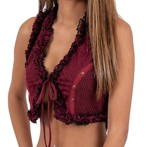 May include: A burgundy lace crop top with a black lace trim and a tie closure at the front. The top has a mesh panel on the back.