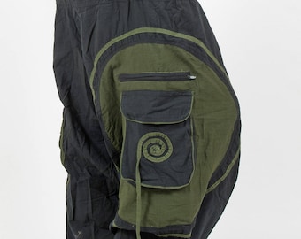 May include: Black and green cargo pants with a large pocket on the right leg. The pants have a drawstring waist and a relaxed fit.