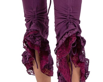 May include: Purple cropped pants with a lace trim at the bottom. The pants have a drawstring at the bottom of the legs.
