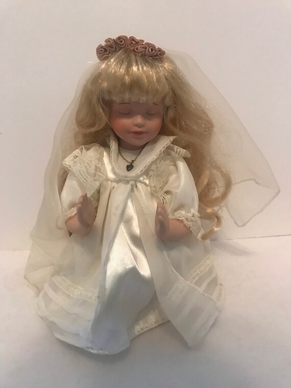 praying porcelain doll