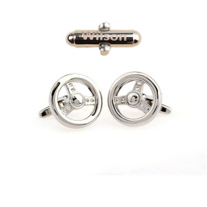 May include: Silver cufflinks with a steering wheel design. The cufflinks are engraved with the name "Wilson".