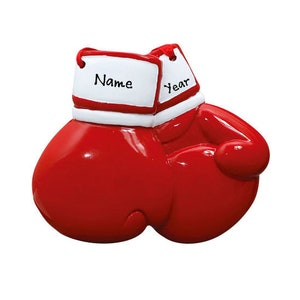 May include: Red and white boxing glove Christmas ornament with a blank space for a name and year.