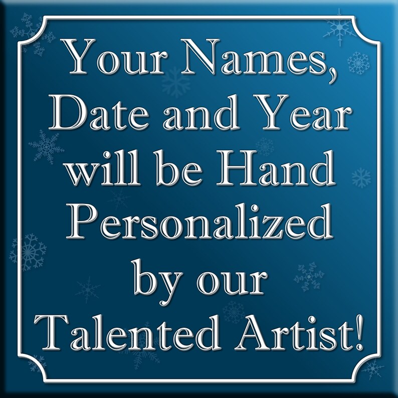May include: A blue square sign with white snowflakes and white text that reads "Your Names, Date and Year will be Hand Personalized by our Talented Artist!"