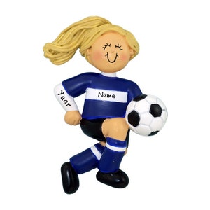 May include: A blue and white soccer player ornament with blonde hair and a smiling face. The ornament has the text "Name" and "Year" on it.