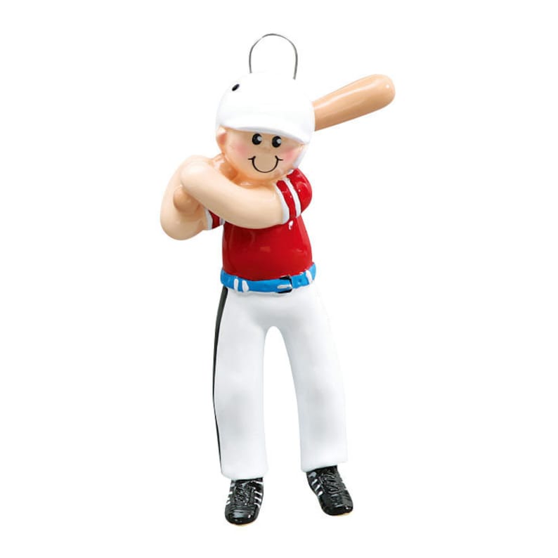 May include: A baseball-themed ornament featuring a figure in a red baseball jersey, white pants with black stripes, and a white helmet. The figure is holding a wooden baseball bat, ready to swing. The ornament has a smiling face and black shoes.