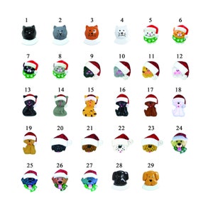 May include: A selection of 29 Christmas ornaments depicting cats and dogs. Each ornament has a unique colour and design, with many wearing Santa hats and festive scarves. The ornaments are numbered 1 to 29.