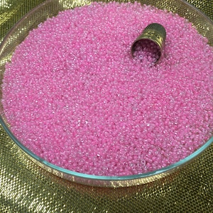 50g of small pink glass beads, antique seed beads, in bulk. 5000 Vintage pink glass seed beads in bulk. Loose beads.