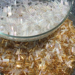 3000 Vintage glass bugle beads, clear iridescent and gold colors.  Old glass beads in bulk.140g.