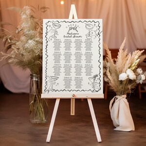 Könnte beinhalten: Ein weißer, druckbarer Sitzplan für eine Bridal Shower mit dem Text "Cheers! Madison's Bridal Shower" oben. Der Plan ist in 14 Tische unterteilt, wobei sich oben auf jeder Spalte eine Schwarzweißillustration eines Cocktailglases befindet.