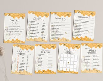 May include: A set of ten printable baby shower game cards with a yellow honeycomb pattern and lavender floral accents. The games include "Don't Say Baby", "Celebrity Baby Names", "Who Knows Mom Best", "Nursery Rhyme Trivia", "Baby Traits", "The Price is Right", "Baby Bingo", and "Would You Rather".