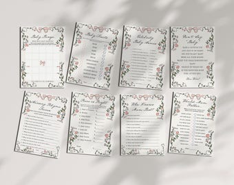 May include: A set of baby shower game cards with floral and bow decorations. The cards include titles such as "Baby Bingo", "Baby Traits", and "Celebrity Baby Names". The design is soft and feminine, with a vintage style.